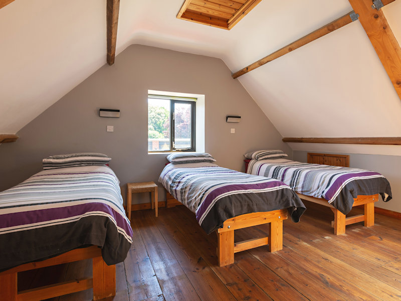 Private rooms self catering accommodation, quad Room with 4 single beds with an ensuite shower room in The Stables - Deepdale Camping & Rooms
